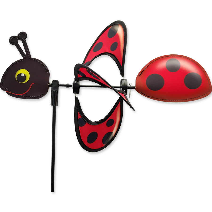 Petite Spinner - Ladybug spins gently in a garden, showcasing its bright colors and charming design in an outdoor setting.