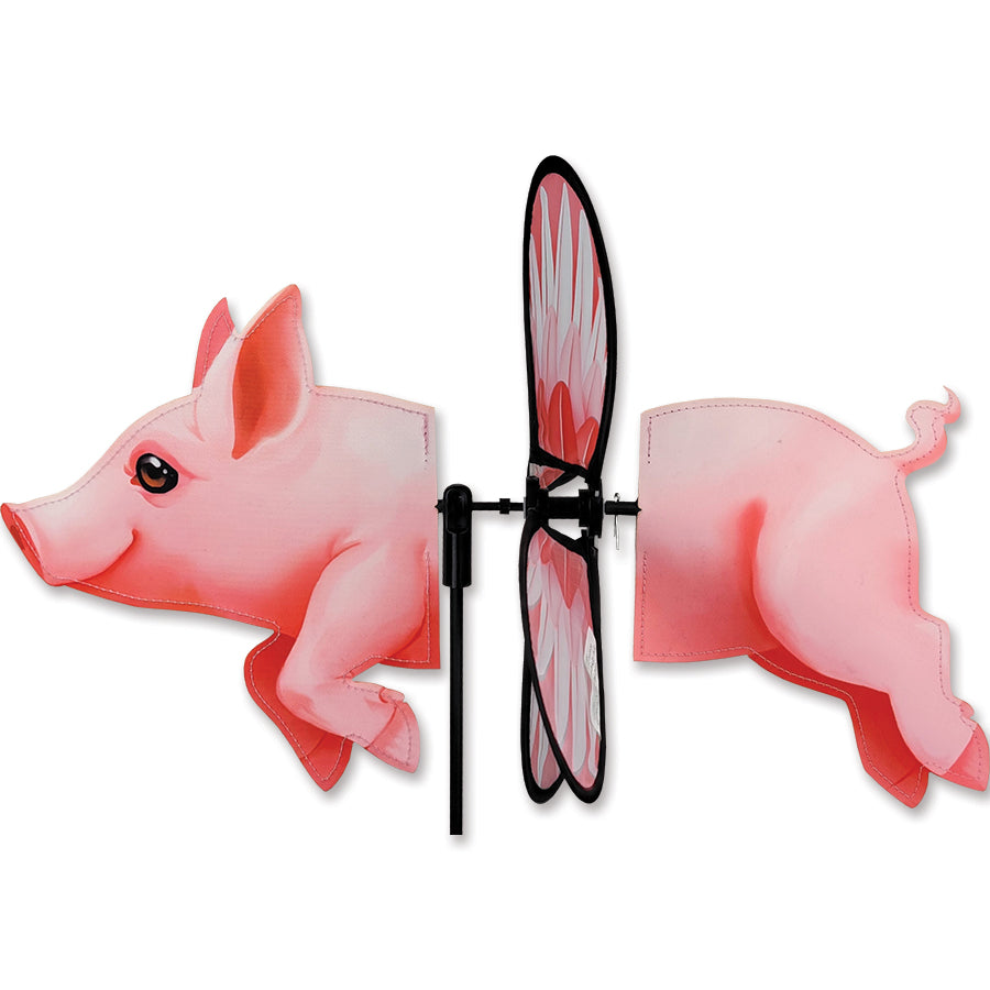 Petite Spinner - Pig garden decoration with colorful pig design, gently spinning in an outdoor garden setting surrounded by plants.