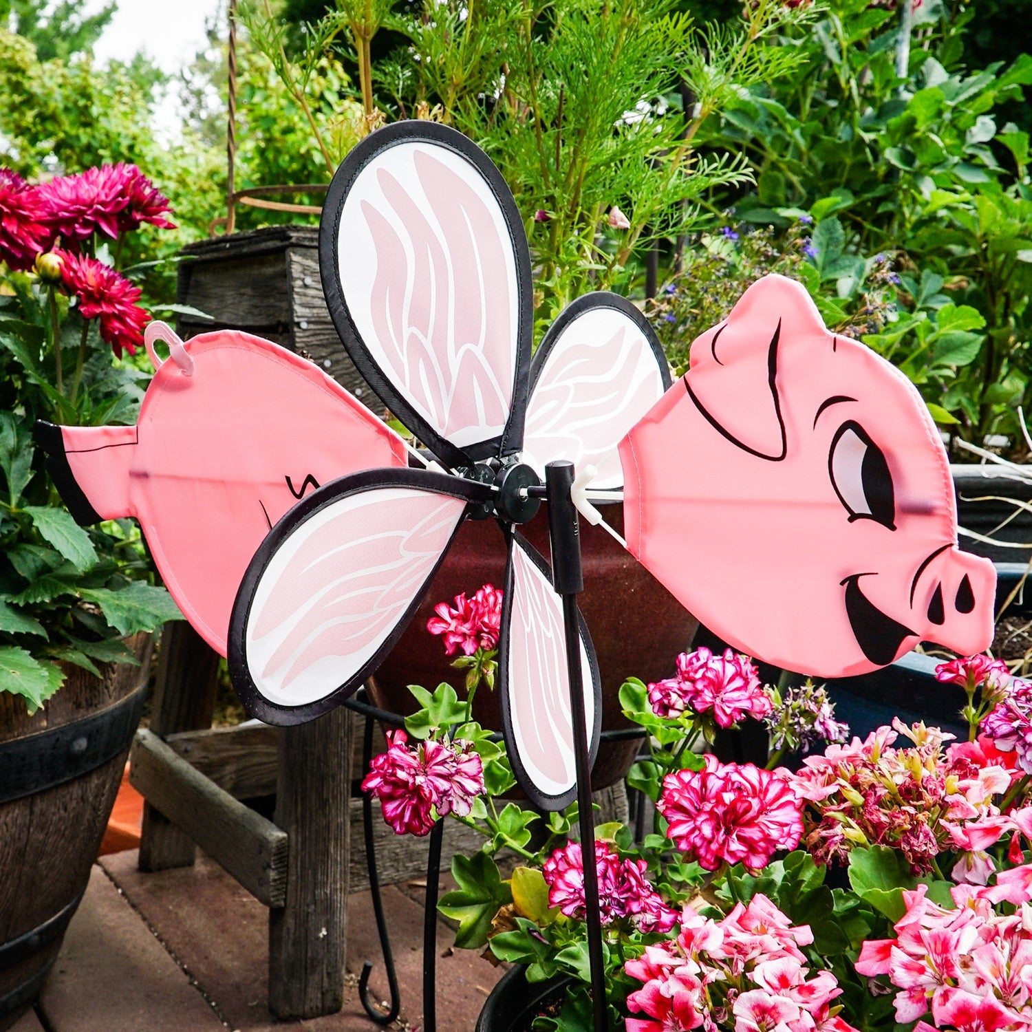 Piggy Baby Spinner features a charming baby flying pig design, made with vibrant fade-resistant polyester, twirling beautifully on a fiberglass frame in any outdoor setting.
