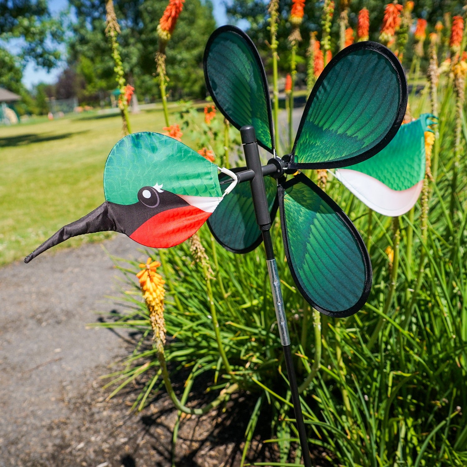 Pivoting Hummingbird Spinner featuring a colorful 15-inch petal wheel, showcasing hummingbirds, spins and pivots in the garden.