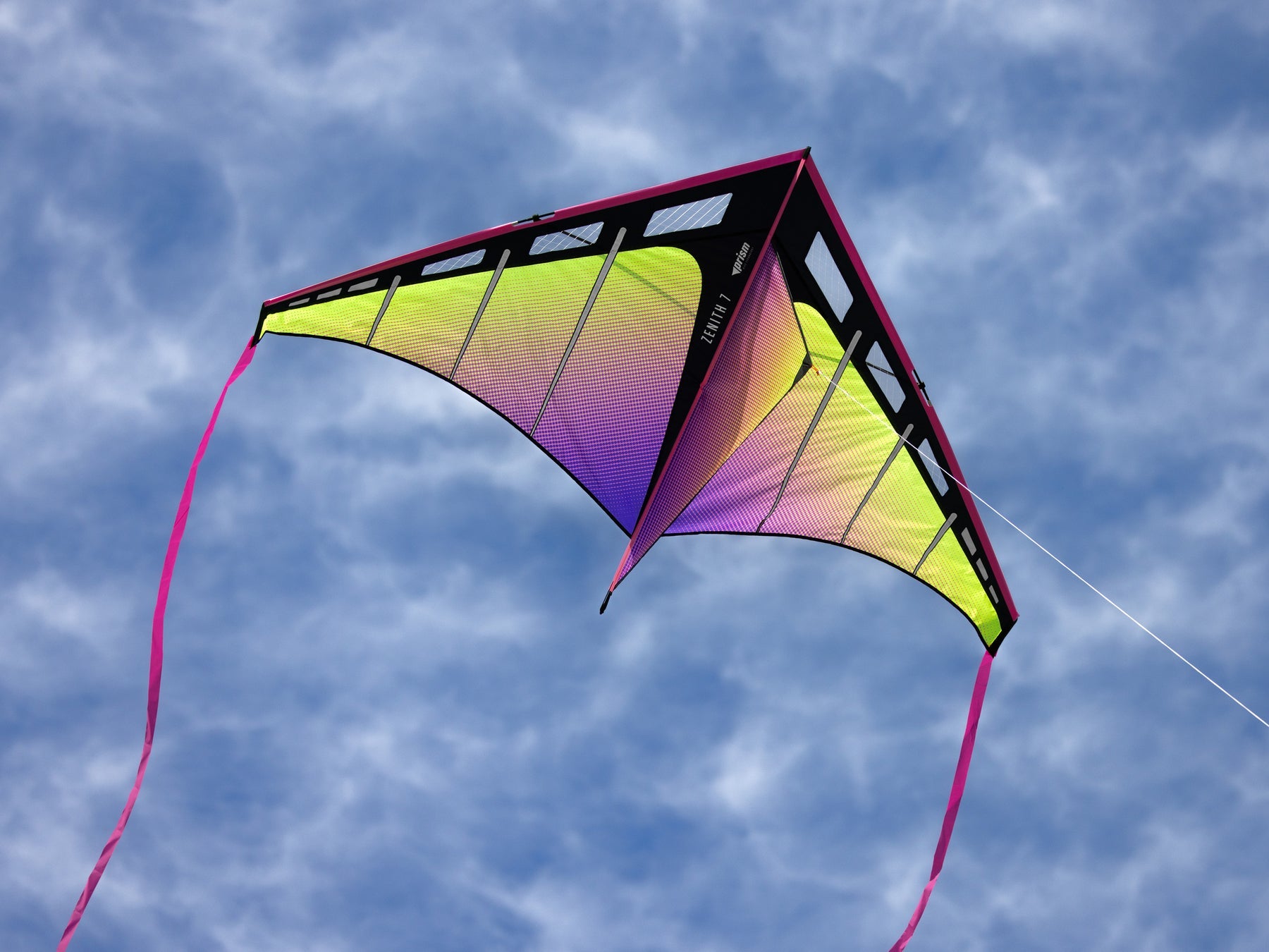 large delta kite with 7 foot wingspan flying in open sky with ribbon tails and strong pull for lifting accessories