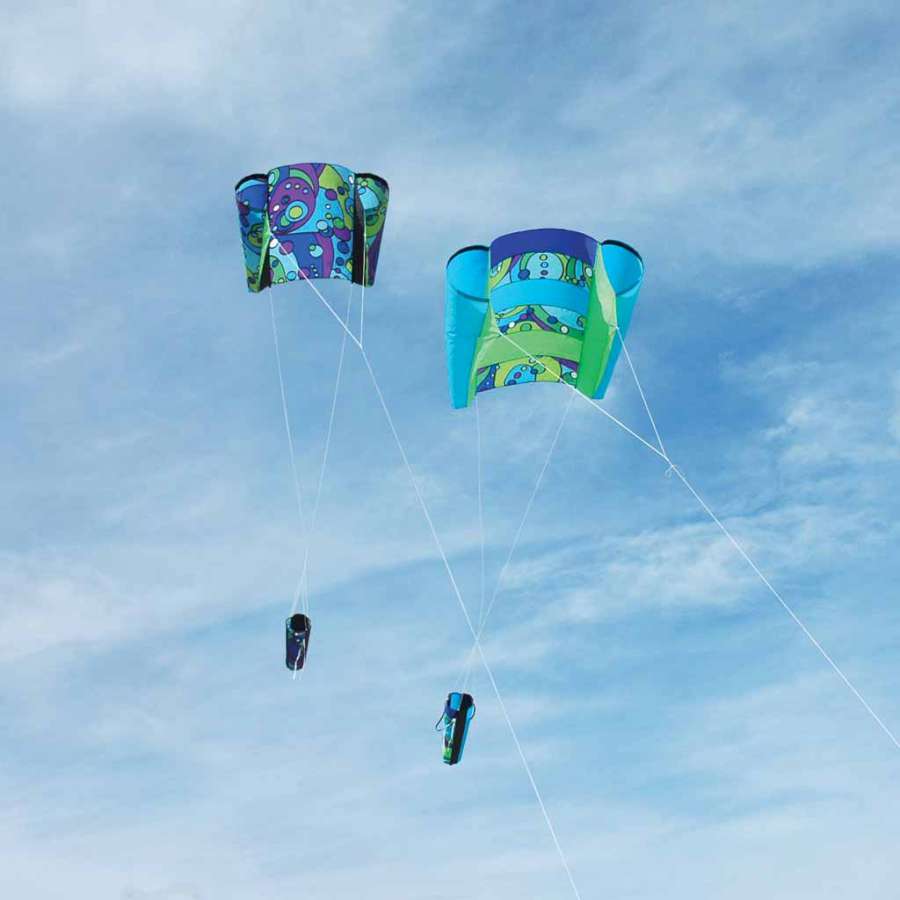 Power Sled 10 Kite - Cool Orbit flying in the sky, showcasing its vibrant design with a backdrop of blue clouds.