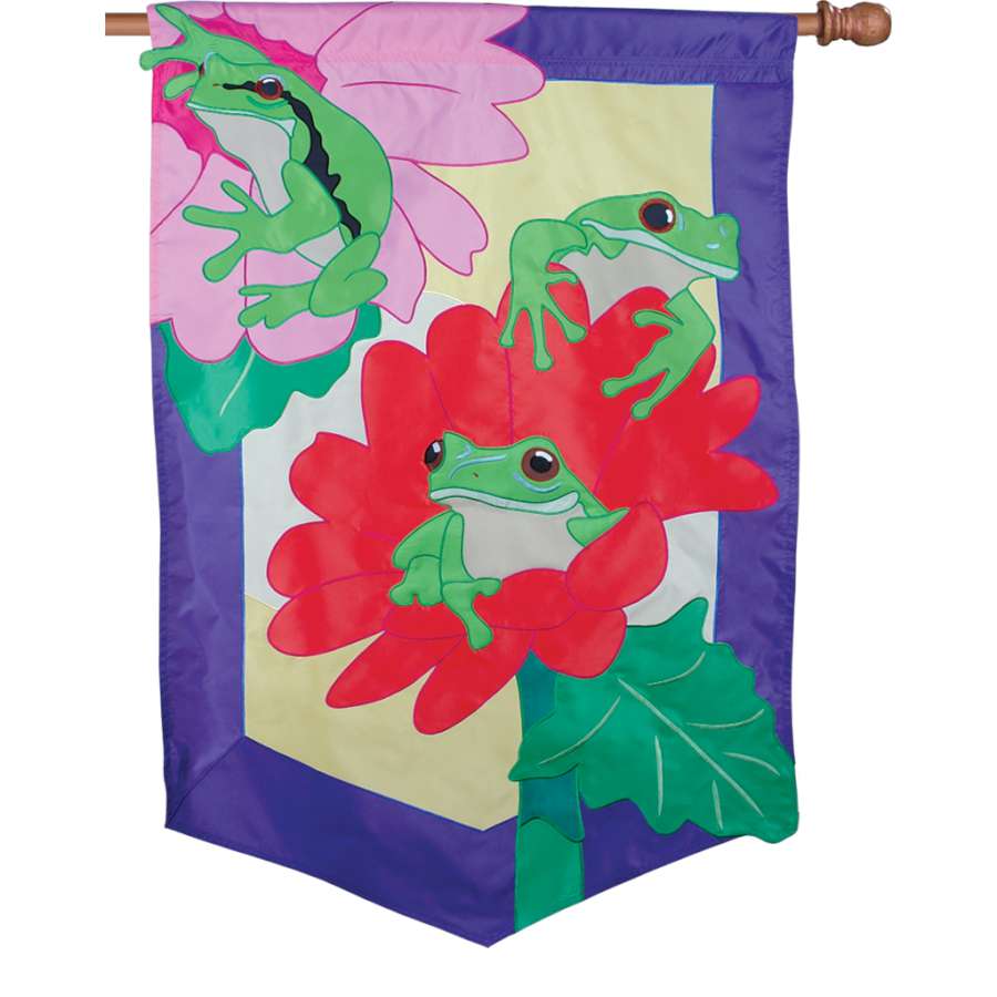 View of the Prestige Flag - Peek-A-Boo displayed outdoors, showcasing its oversized 3-D applique design on a flag pole against a garden backdrop.