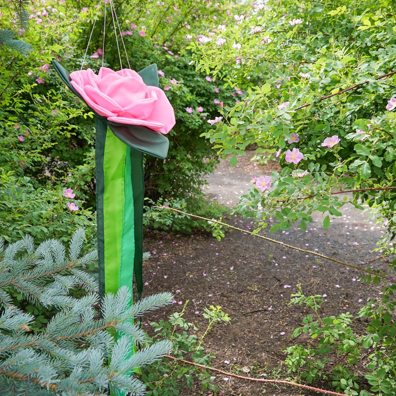 Pretty as a Rose Floral Windtail featuring 3D rose blossoms and color-coordinated tails hanging gracefully in an outdoor setting.