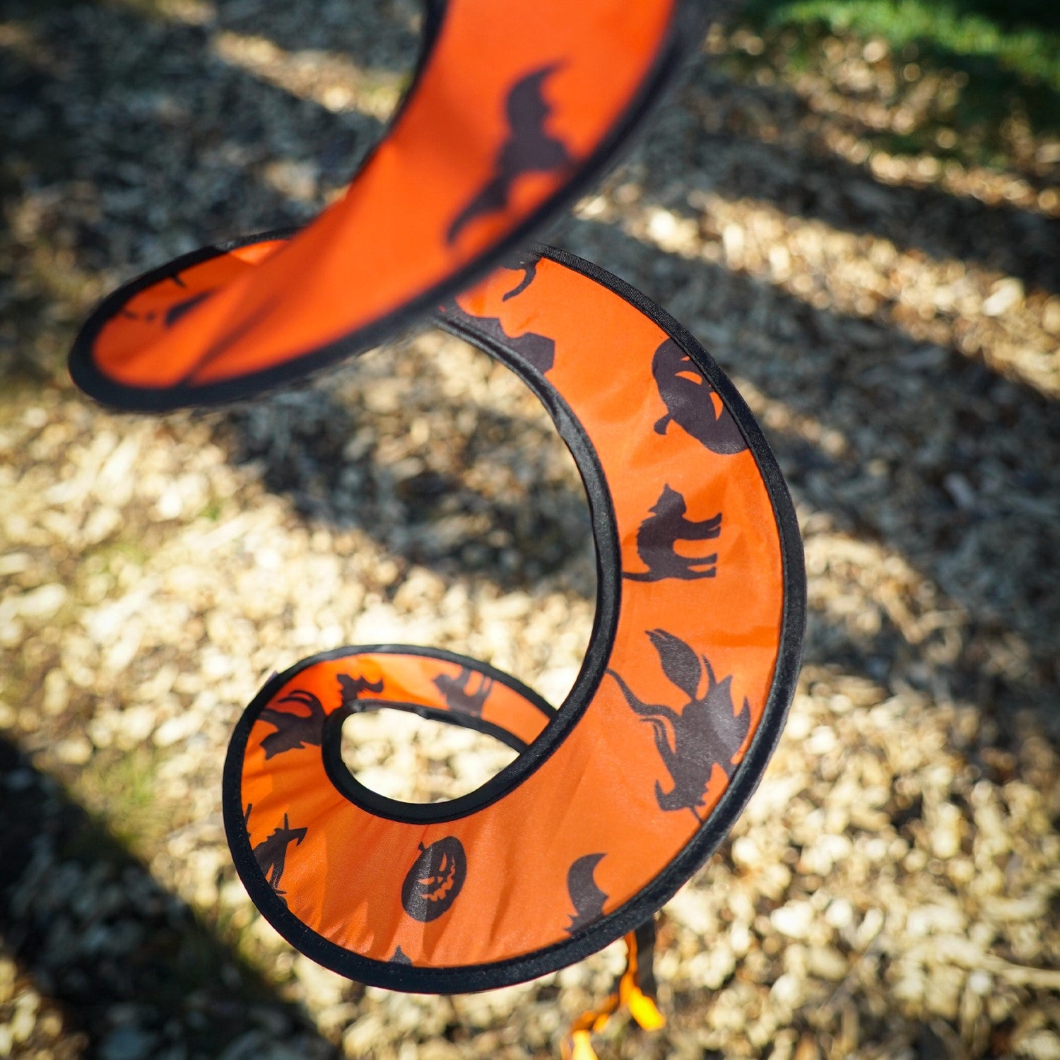 Pumpkin with Hat Hanging Ball Spinner featuring a friendly pumpkin face and colorful hat, spinning in a garden setting during autumn.