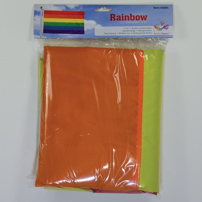Rainbow 5x8 grommet flag with vibrant colors, secured with brass grommets, fluttering proudly in an outdoor setting, perfect for celebrations.