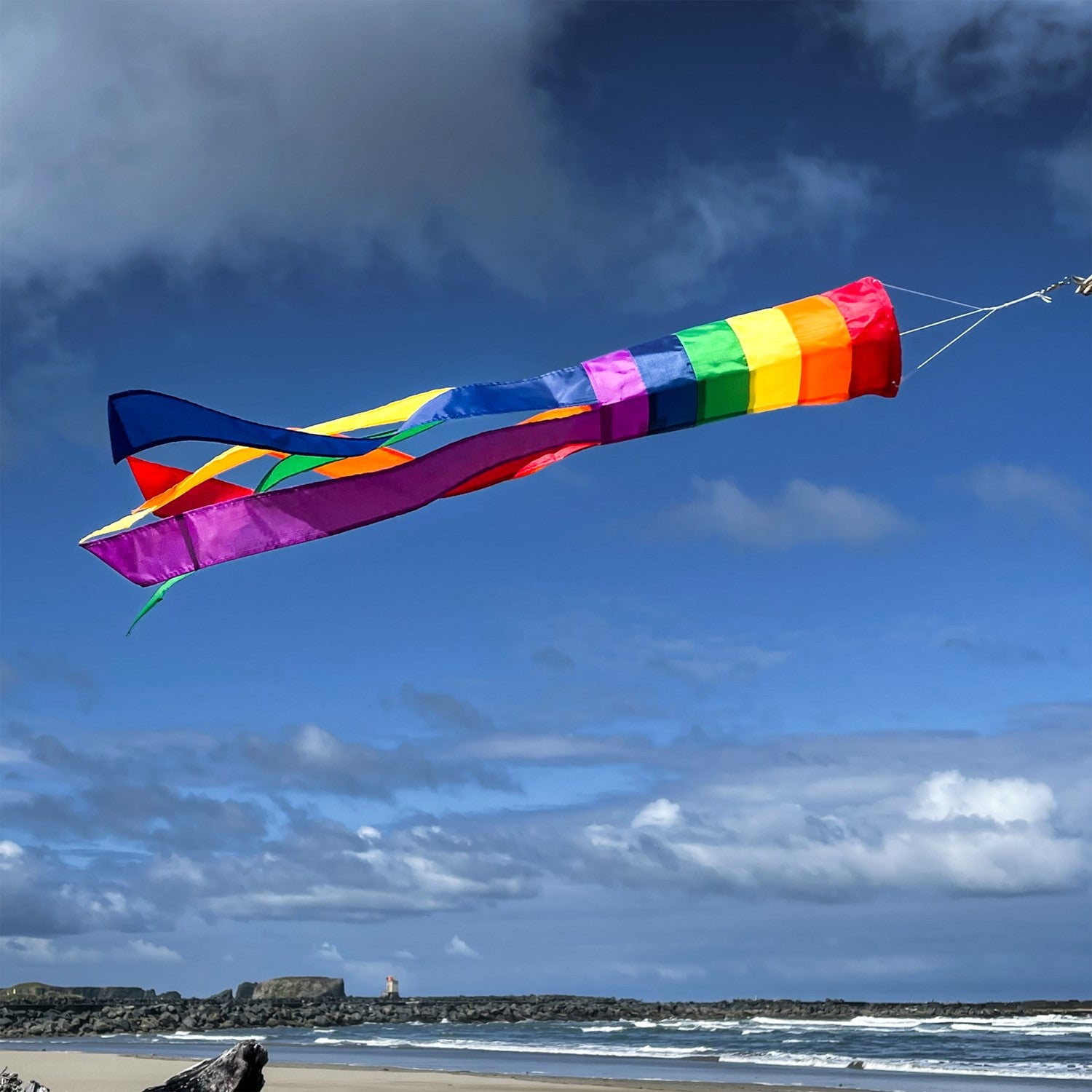 Rainbow Column 33" Windsock featuring vibrant colors and long tails dancing in the breeze, ideal for adding a joyful touch to any outdoor setting.