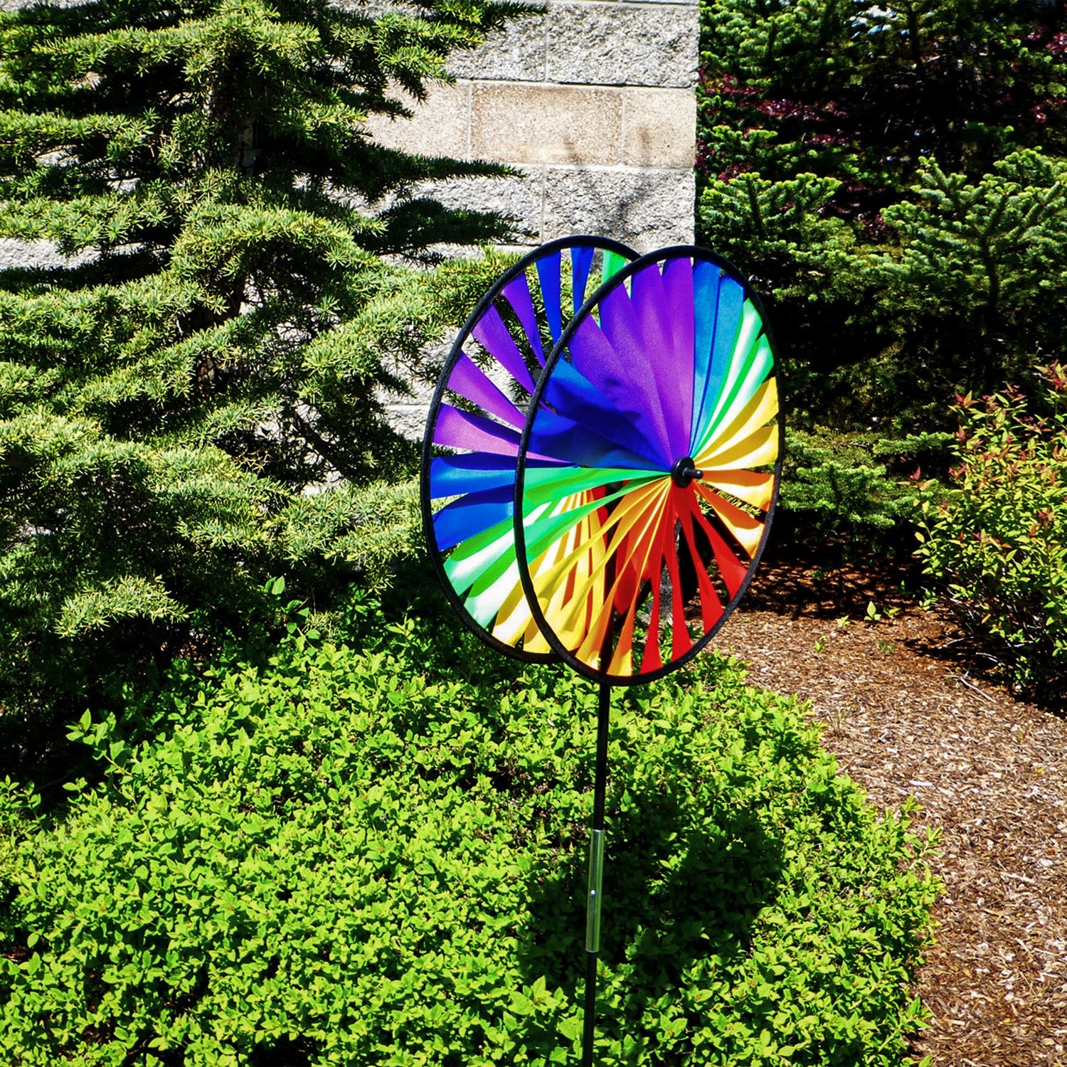 Rainbow Duo Wheel Spinner featuring two colorful spinning wheels on a fiberglass pole, creating a vibrant outdoor decoration.