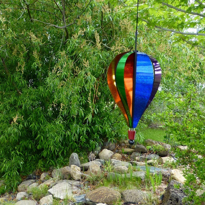 Rainbow Glitter 6-Panel Hot Air Balloon in an outdoor setting, showing colorful sparkling Mylar and ready to spin in the breeze.