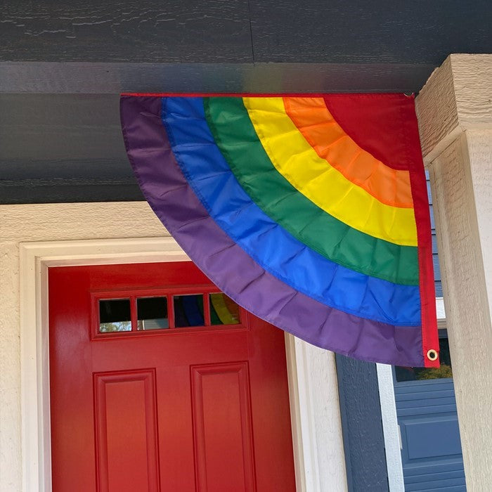 Set of 2 Rainbow Ruffle Corner Bunting flags with six sewn panels showcasing a vibrant rainbow spectrum, displayed outdoors.
