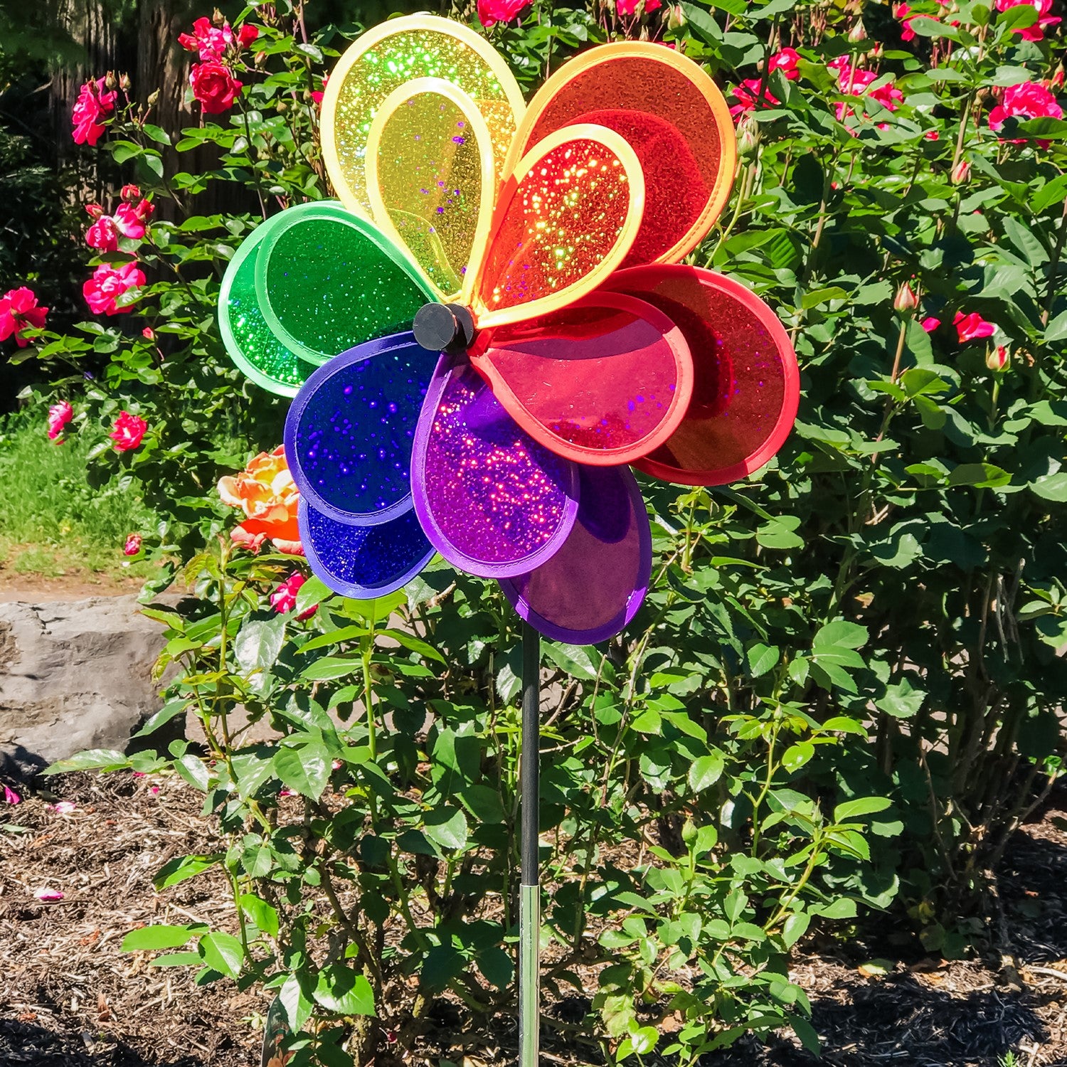 Rainbow Sparkle Double Flower garden spinner featuring double Mylar petals in a brilliant rainbow spectrum, easily rotates in the breeze to brighten gardens.