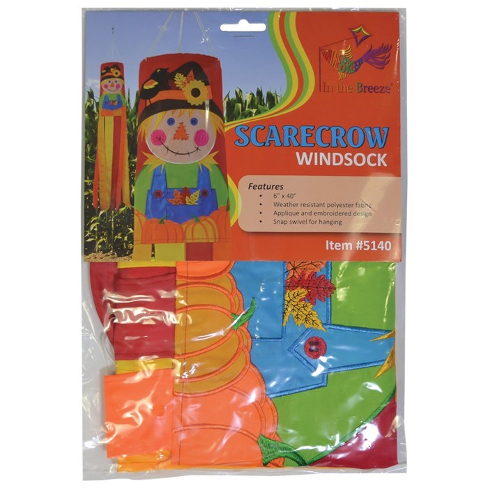 Scarecrow 40" Windsock displayed outdoors, featuring vibrant autumn colors and delightful scarecrow design with fluttering tails in a garden setting.