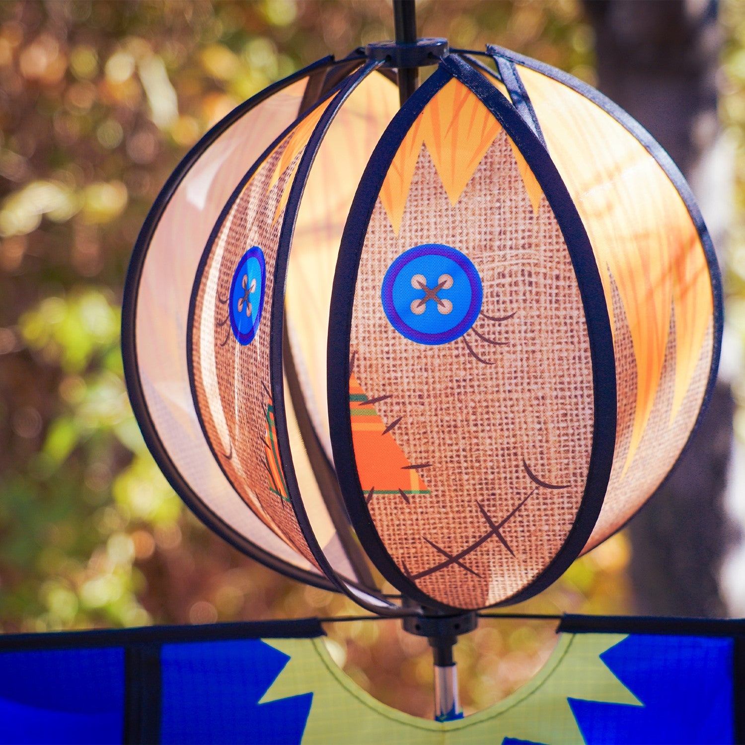 Scarecrow Hanging Ball Spinner made of weather-resistant materials, showcasing a friendly scarecrow head spinning in the wind to bring seasonal joy to your garden.