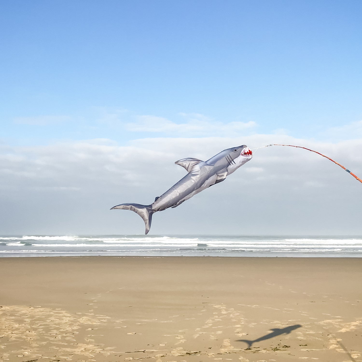 Shark 48" Fish Windsock featuring a realistic great white shark design, elegantly displayed in a backyard setting near the water.