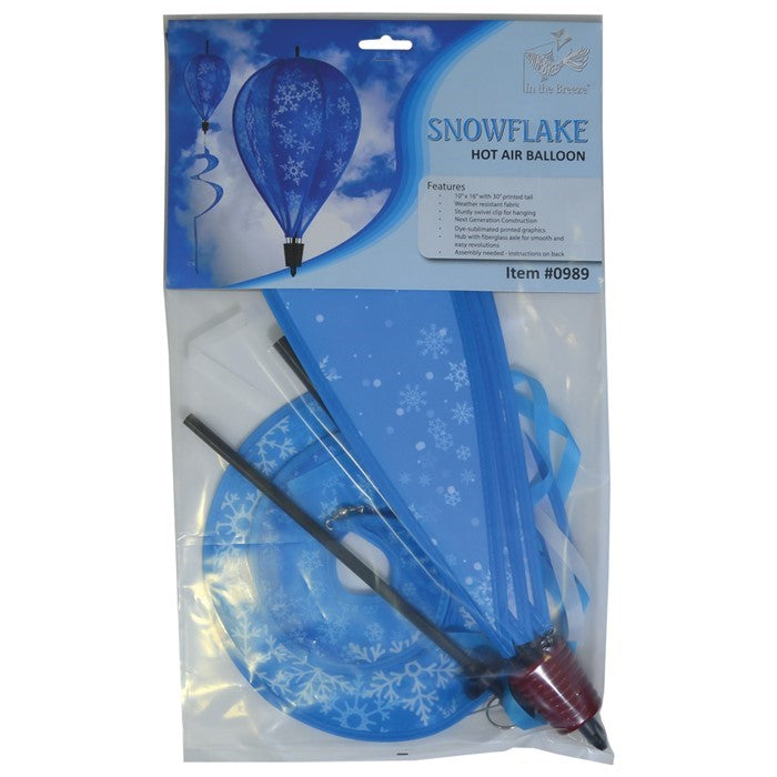 Snowflakes 6-Panel Hot Air Balloon spinner with a vibrant snowflake design, spinning gracefully in an outdoor winter setting, showcasing its festive charm.