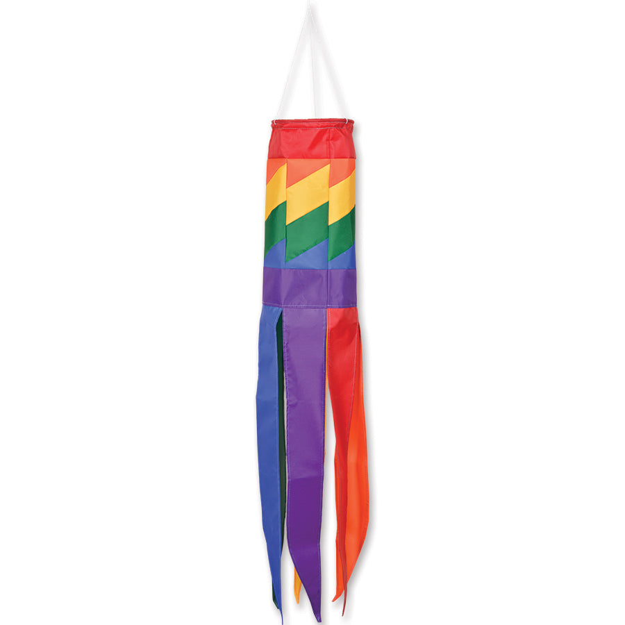 SoundWinds Rainbow Windsock, 39 inches long with colorful tails, displayed in a garden swaying in the breeze against a clear sky.
