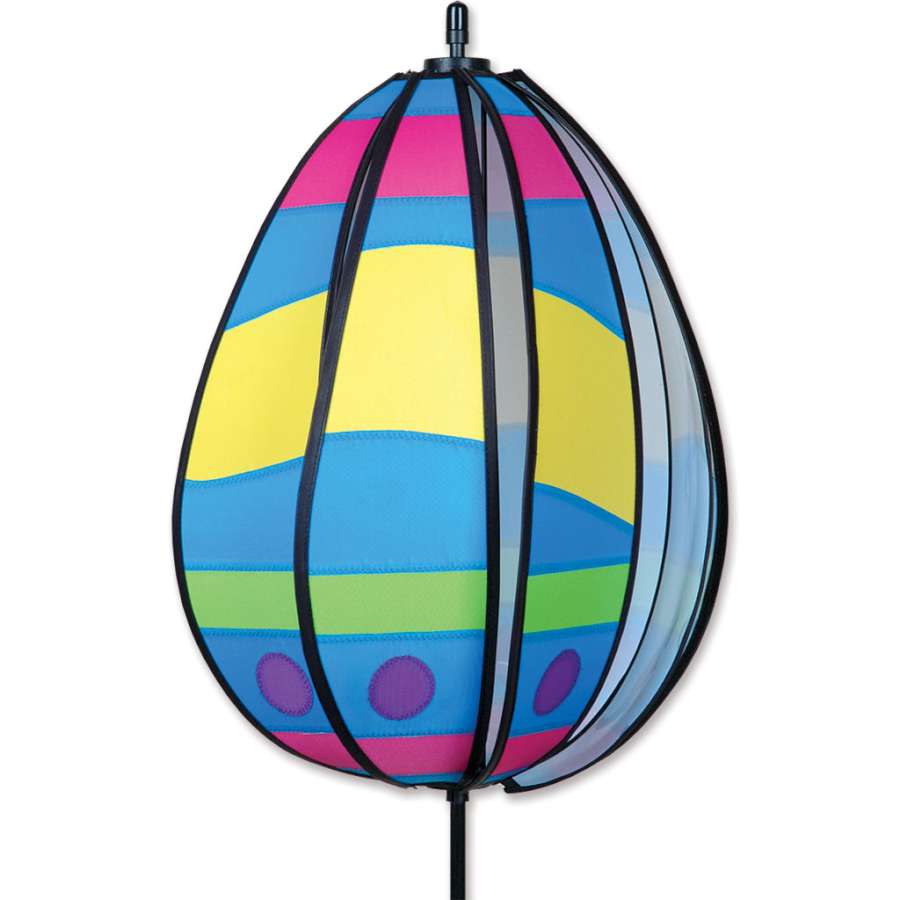 Spinning Egg Spinner - Wavy Yellow displays a vibrant wavy design, twirling in a garden, bringing festive charm to any outdoor setting.