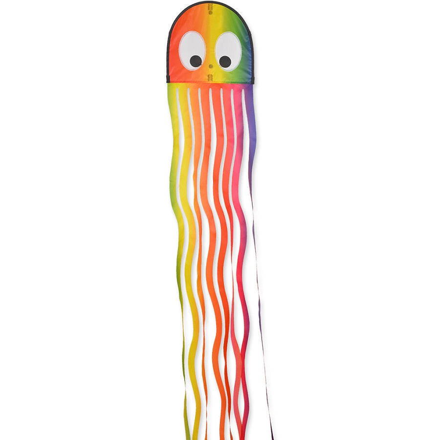 Squeaky Kite - Wavy Gradient displayed in the sky, featuring a colorful octopus tail design, capturing outdoor fun and excitement.