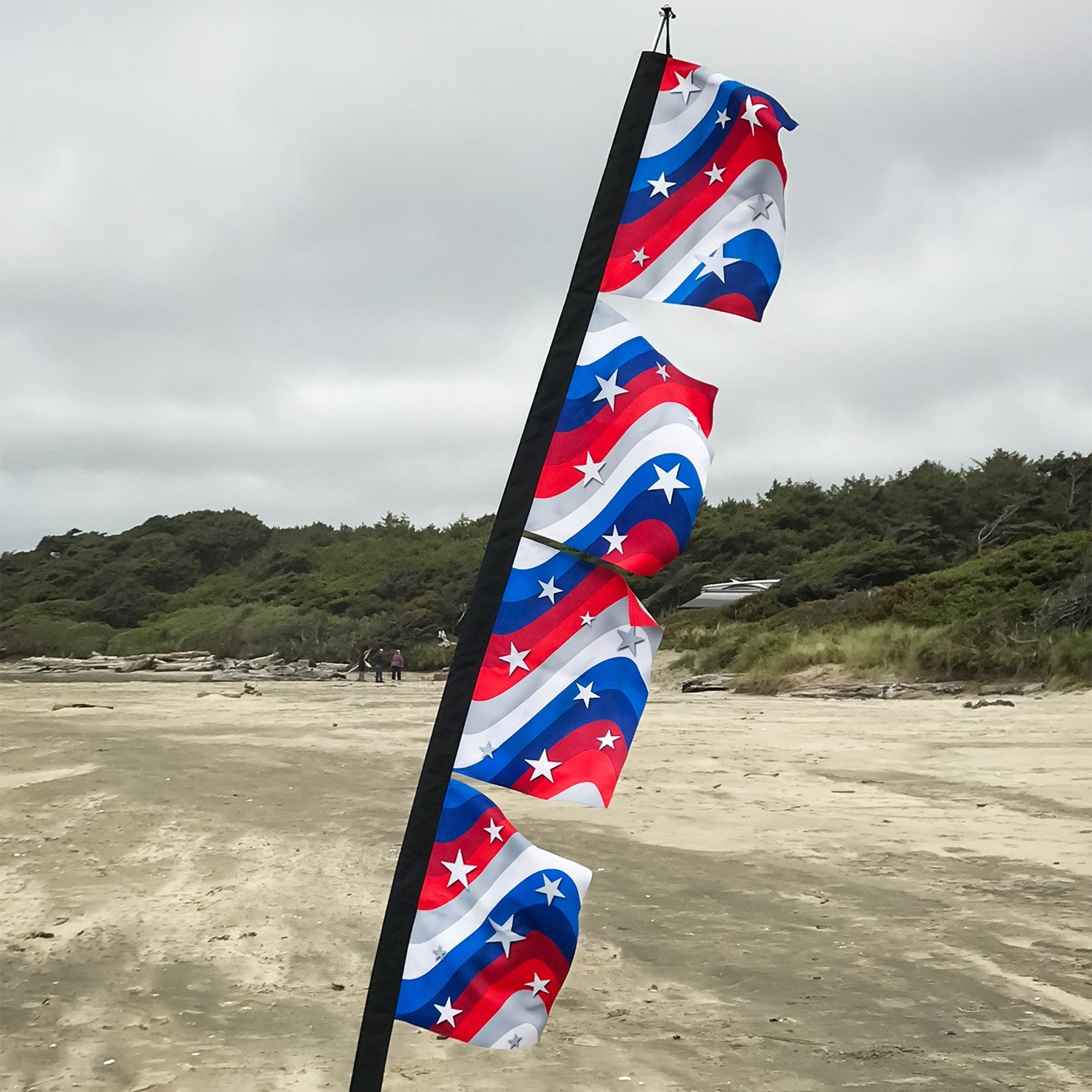 Stars & Stripes 17' x 82' 4-section feather banner displayed outdoors, featuring American flag colors and details visible on both sides.