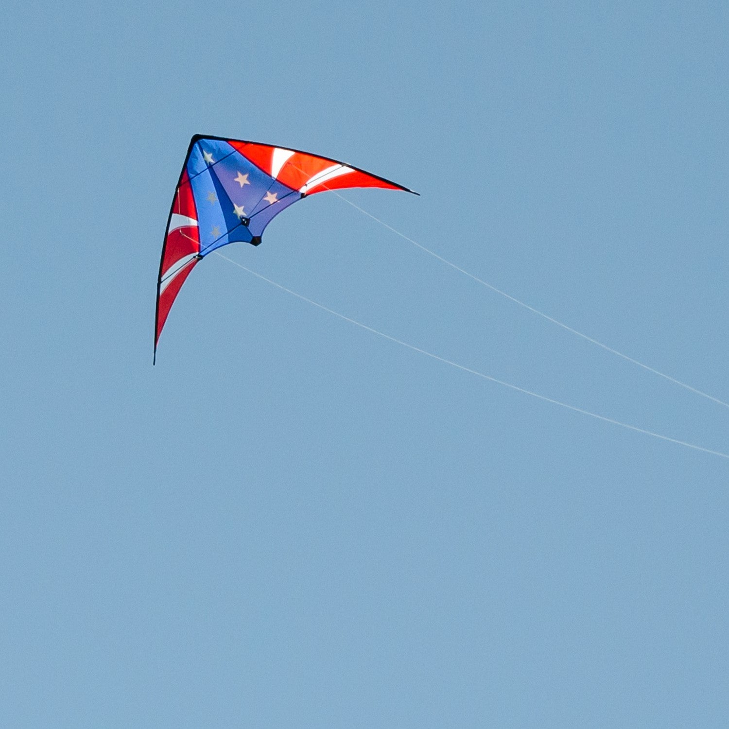 Stars & Stripes 48-inch sport kite with red, white, and blue design flying against a blue sky, showcasing its vibrant colors and dual control.