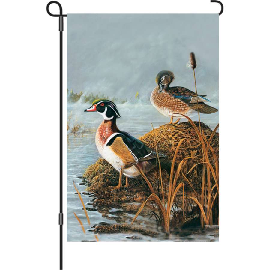 Steamy Wood Ducks illuminated garden flag displayed outdoors, featuring vibrant colors and detailing of wood ducks in a garden setting.