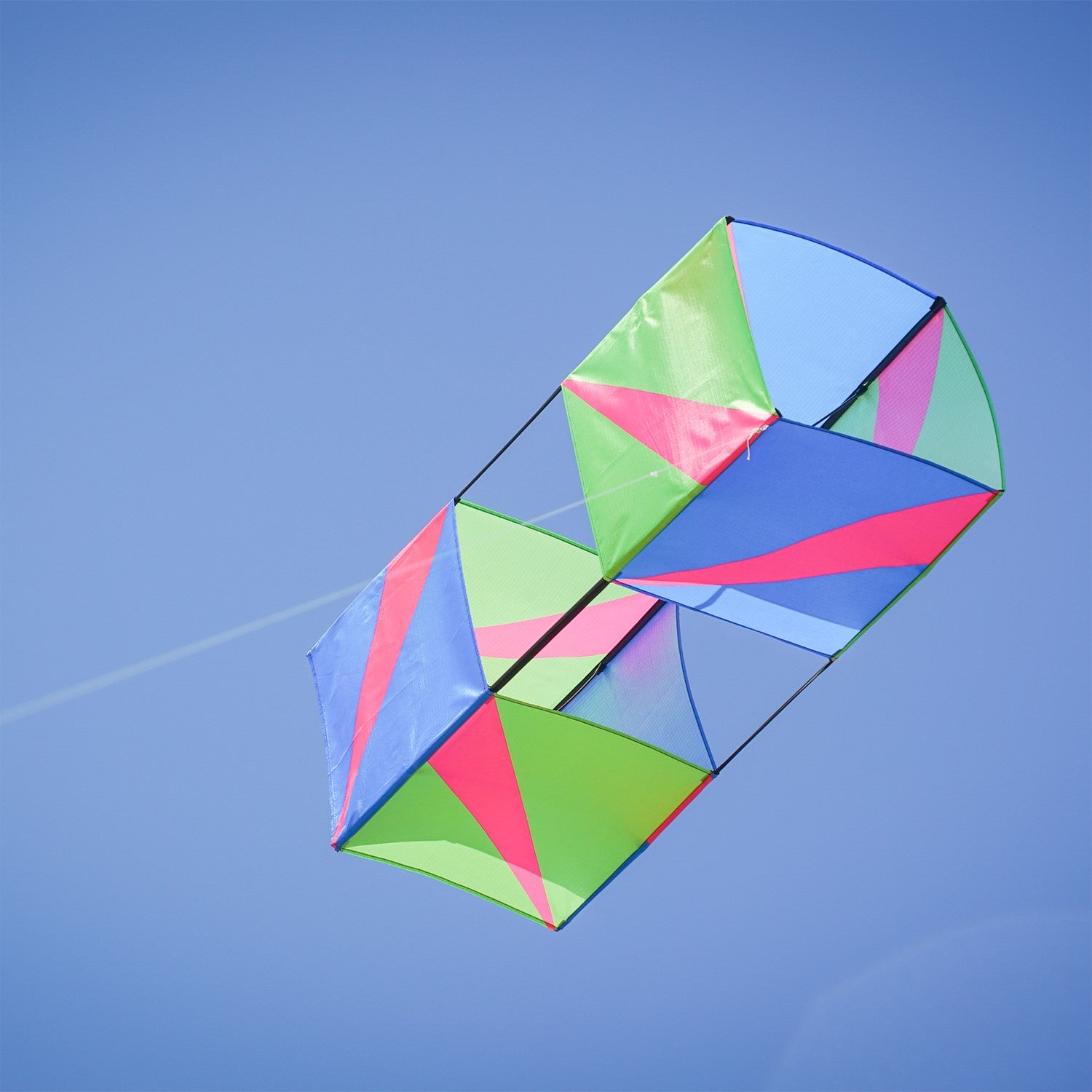 The Strike Double Box Kite soaring in the sky, showcasing its vibrant design and multiple sail surfaces for enhanced stability.