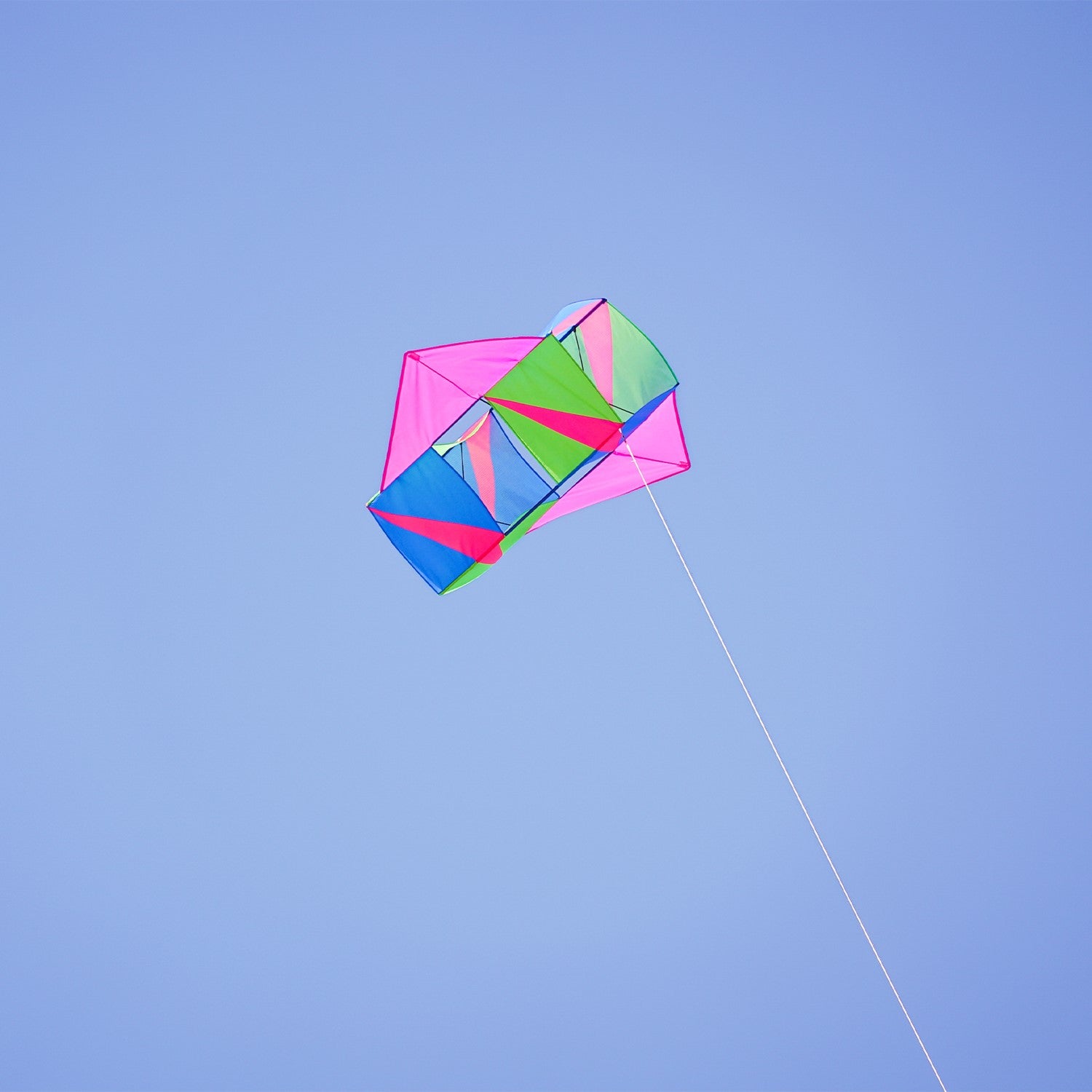 "Strike Winged Double Box Kite with vibrant design and wings displayed flying in a clear blue sky, showcasing its stability and durability.
