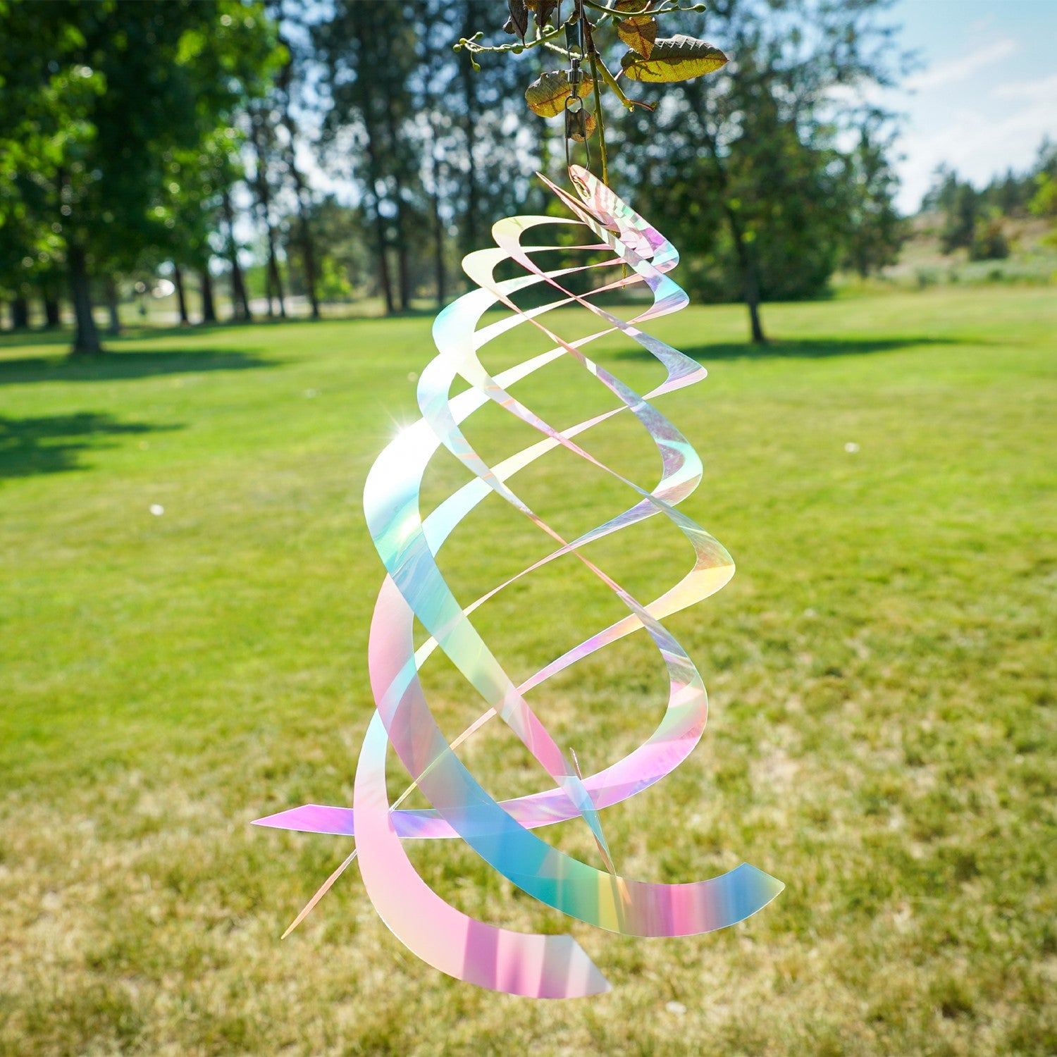 Vibrant Striped Iridescent Crystal Spinner made of Mylar, hanging outdoors with colorful reflections in sunlight, perfect for garden decor.