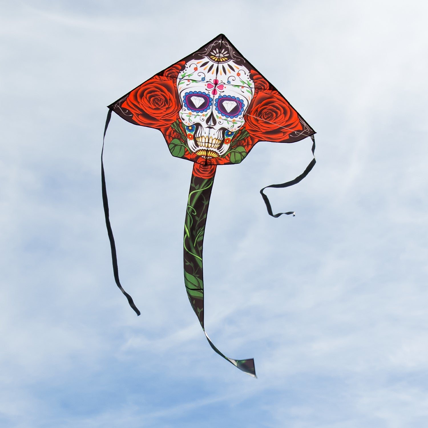 Sugar Skull 45" Fly-Hi Kite featuring a colorful sugar skull design, flying high against a clear blue sky, ideal for family outdoor activities.