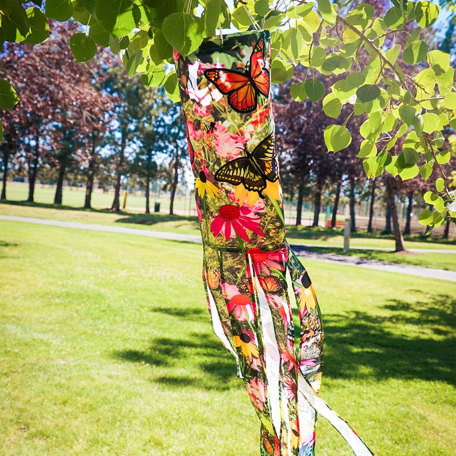 Summer Garden 40-Inch Illusion Windsock with vibrant printed design and embroidered details, gracefully hanging outdoors in a sunny garden setting.
