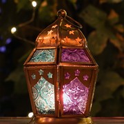 Teal & Purple Hex Glass Tealight Lantern featuring intricate glass and metal design, ready for use to illuminate indoor or outdoor spaces.