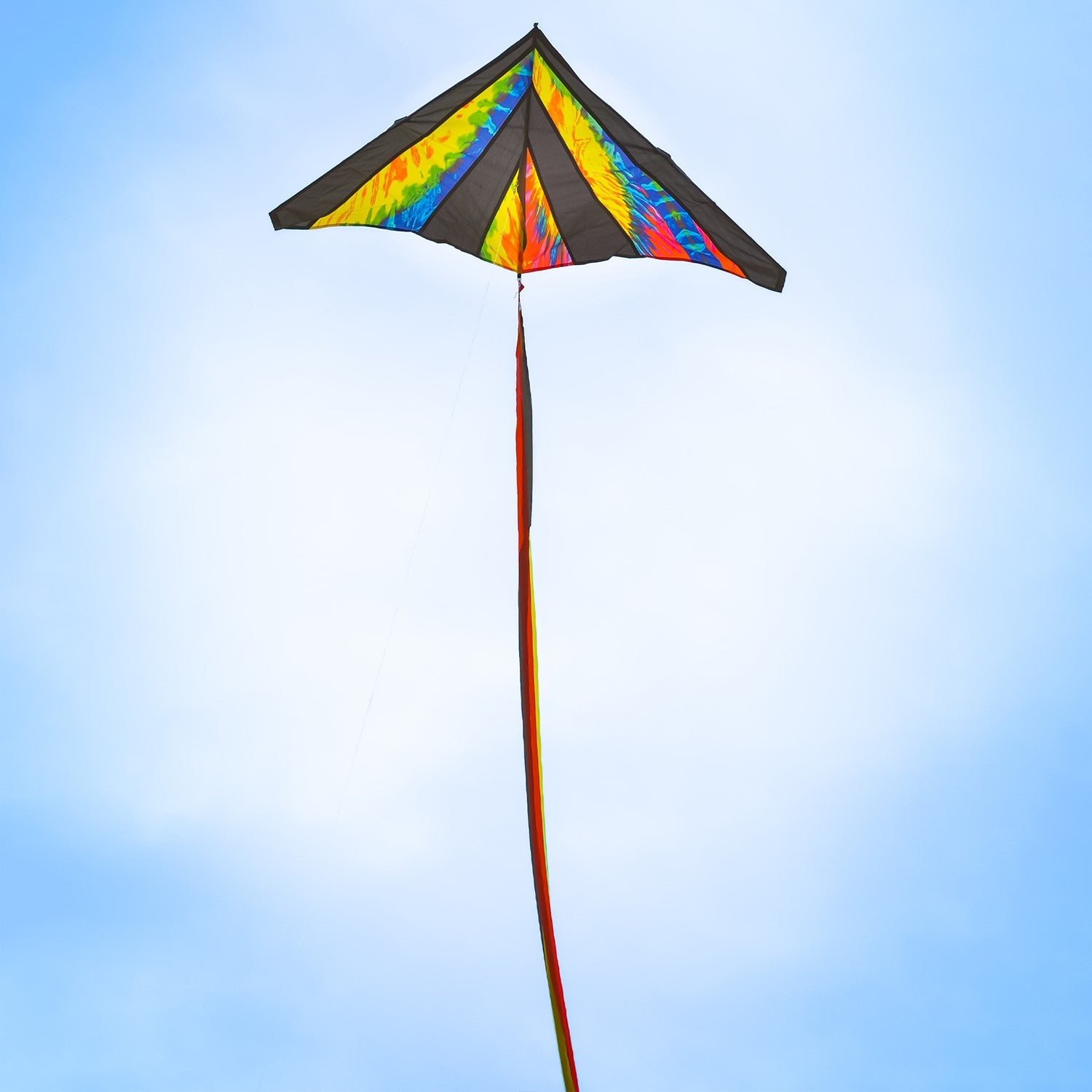 Tie Dye 46" Delta Kite soaring against a blue sky, featuring colorful streamer tails and tie-dye pattern, ideal for outdoor fun.