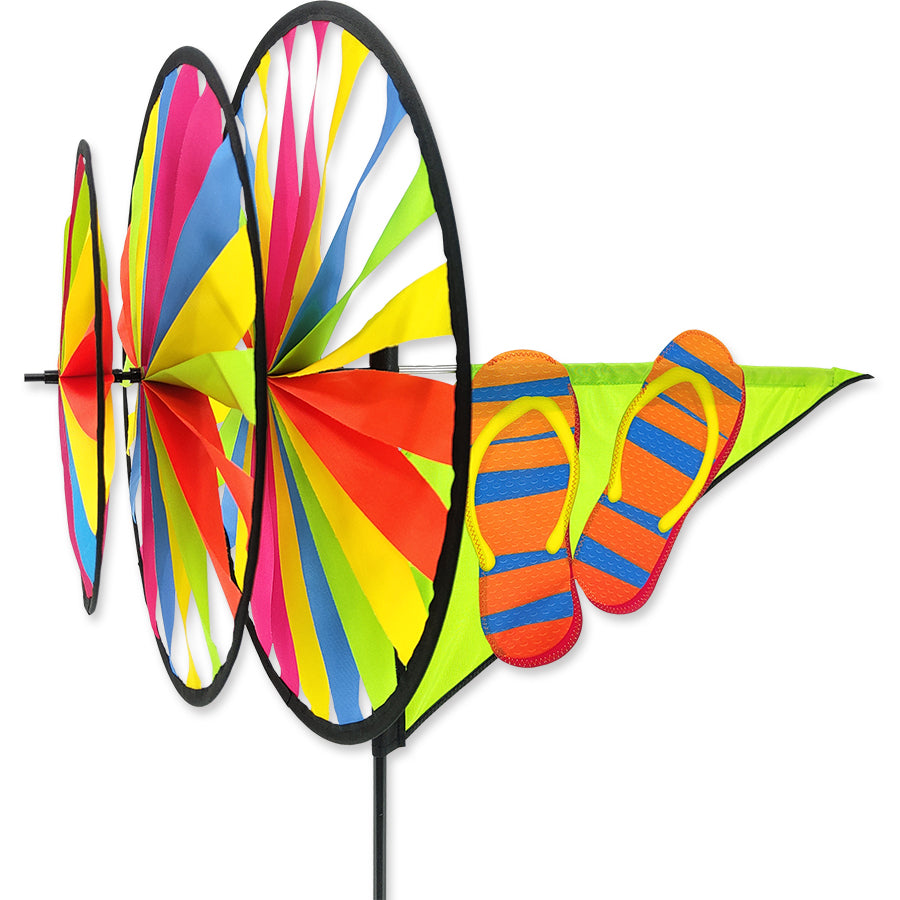 Triple Spinner - Flip Flops made of fade-resistant SunTex fabric, displayed in a garden, showcasing vibrant colors and dynamic movement.