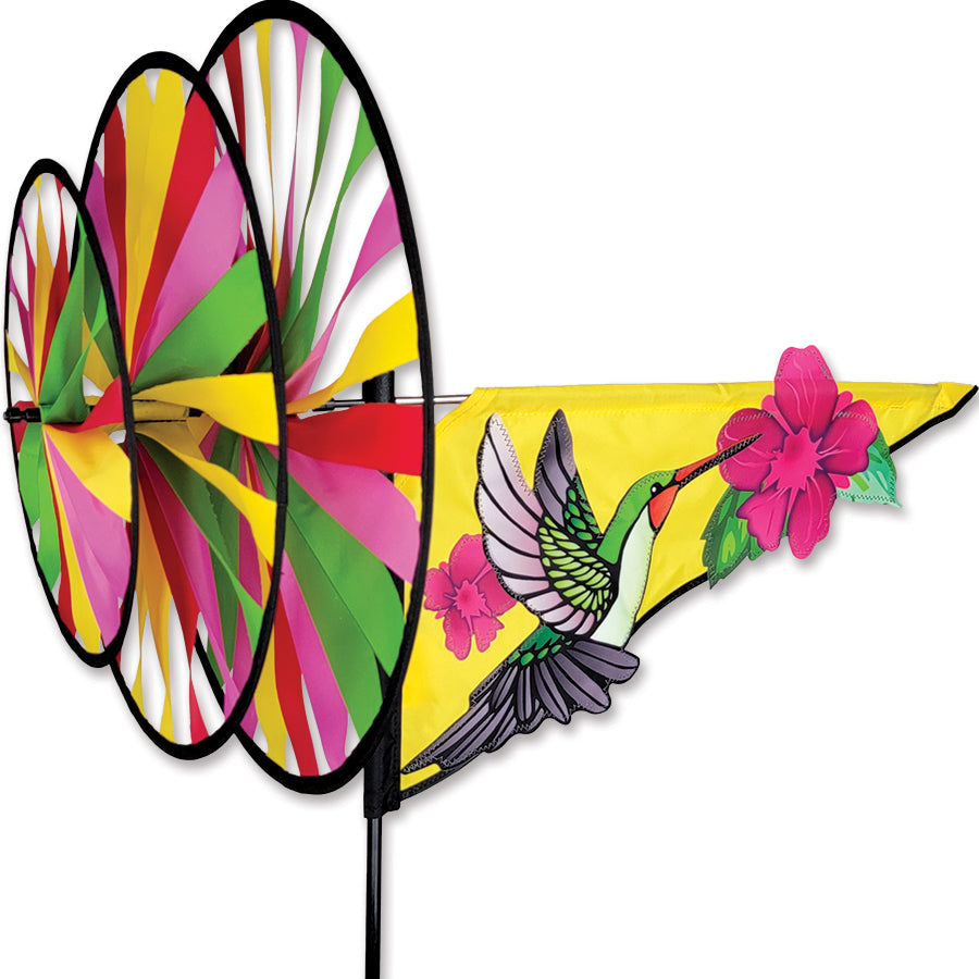 Triple Spinner - Hummingbird vividly displayed in a garden, showcasing intricate spinning action and colorful patterns in sunlight.