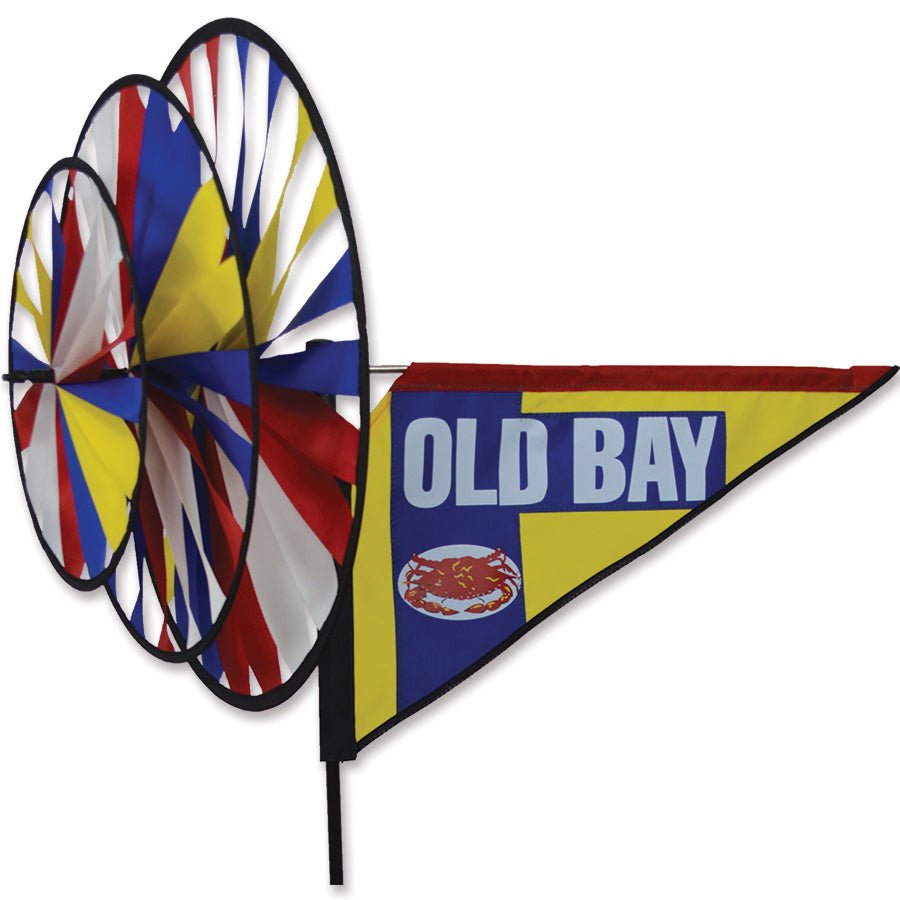 Triple Spinner featuring Old Bay seasoning design, vividly displayed in a garden setting, adding color and charm to outdoor decor.