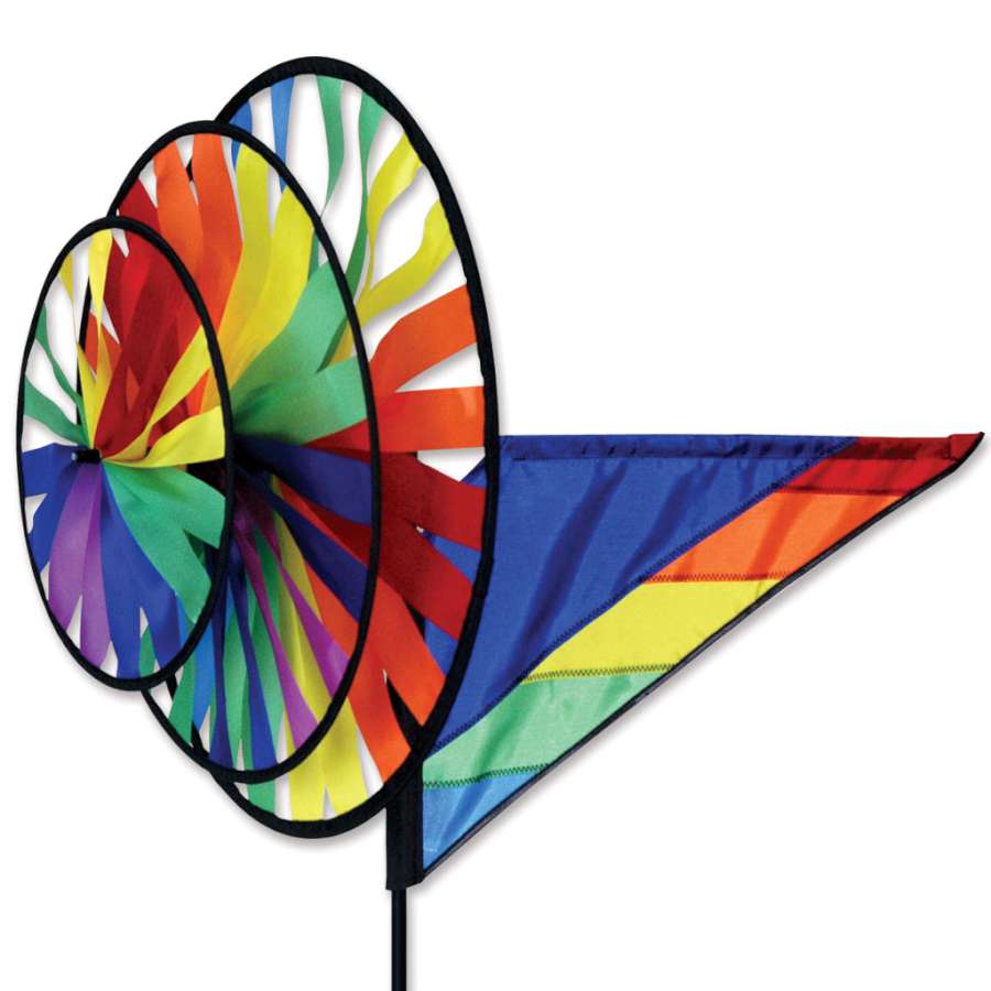 Triple Spinner - Rainbow garden decoration featuring bright, multicolored fabric spinning gracefully in the wind on a sunny day.