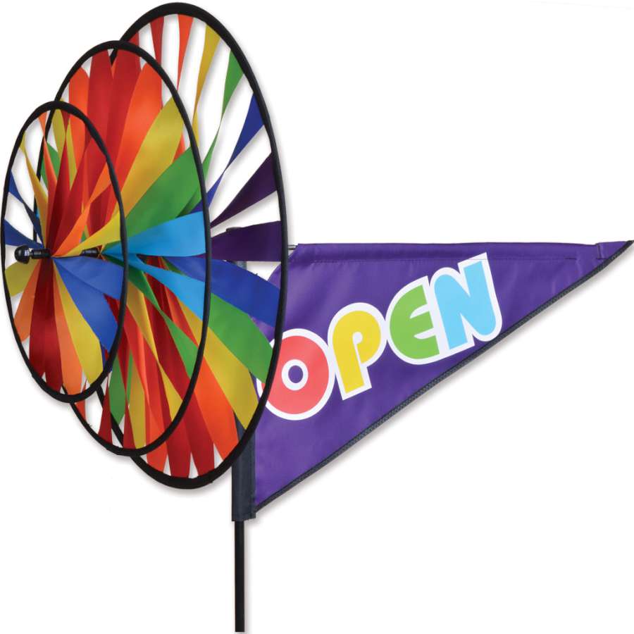 Triple Spinner - Rainbow Open featuring vibrant colors and sturdy fiberglass poles, displayed in a garden setting twirling in the wind.