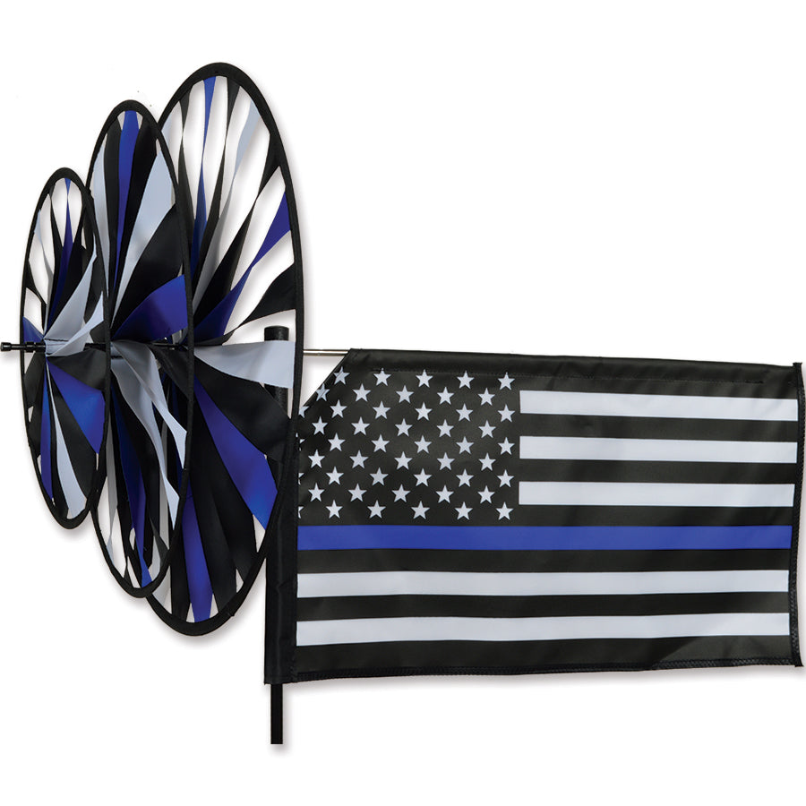 Triple Spinner - Thin Blue Line garden decoration displaying vibrant colors and patriotic design spinning in a residential yard.