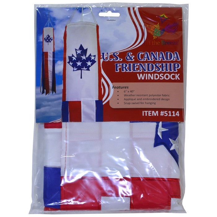 US/Canada Friendship 40' windsock displaying vibrant colors and embroidered graphics, fluttering in the breeze in an outdoor setting.
