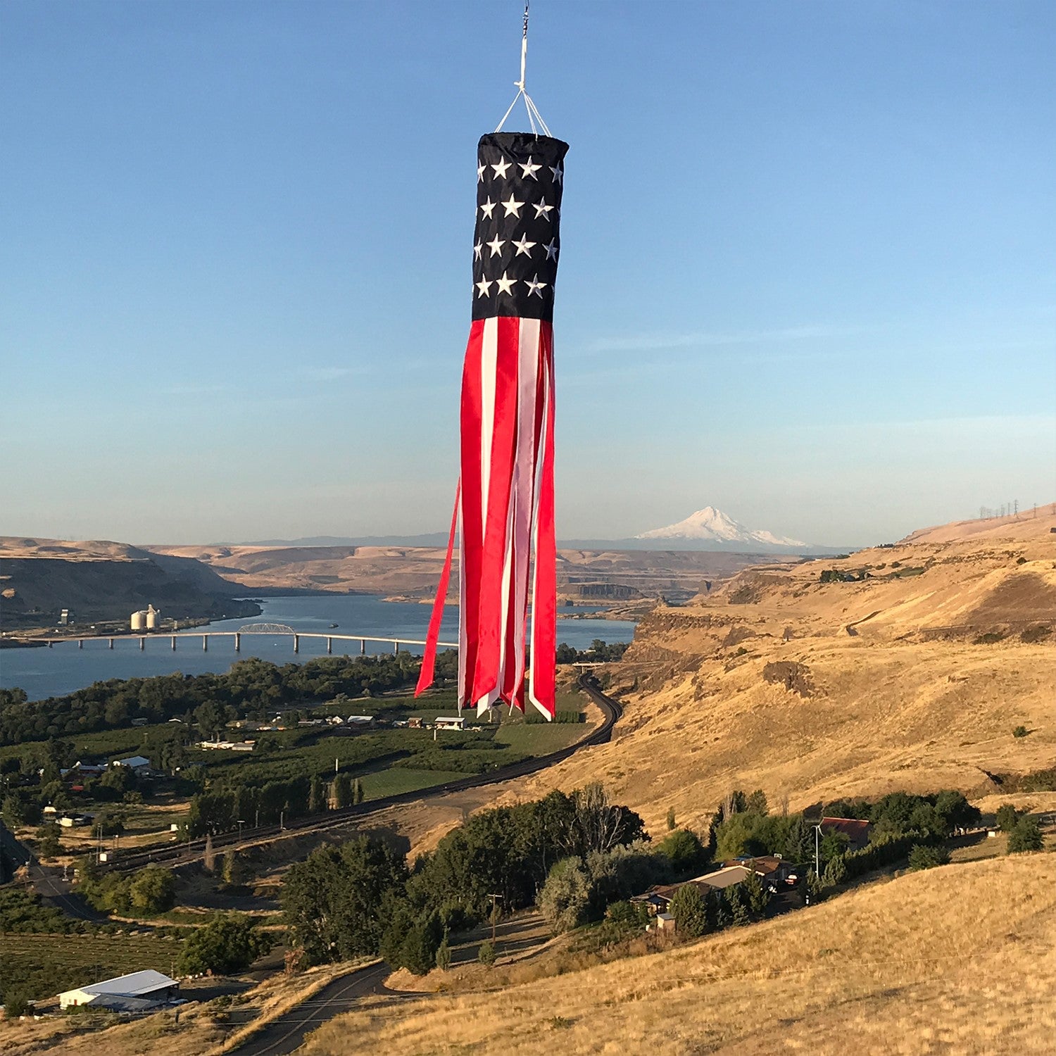 U.S. Stars and Stripes Embroidered 40-inch windsock with embroidered stars and colorful tails, fluttering outdoors in a patriotic display.