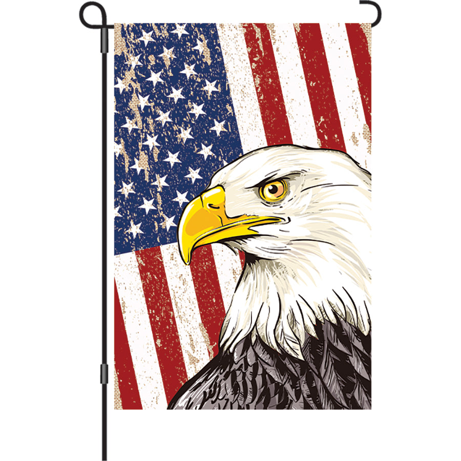Illuminated 12 in. garden flag featuring a majestic eagle design and vibrant colors, displayed in an outdoor garden setting at night.