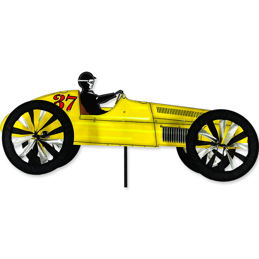 Vintage Race Car model in yellow featuring intricate detailing and authentic racing decals displayed on a shelf in a living room.