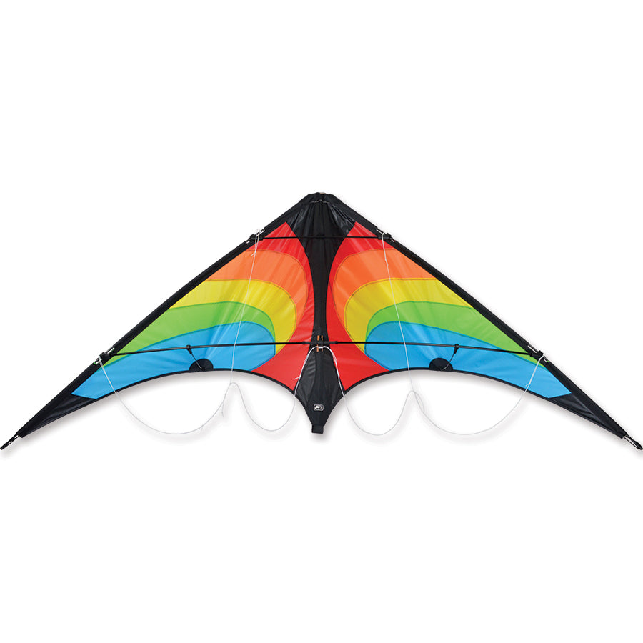 Vision Sport Kite in rainbow colors flying in a clear blue sky, measuring 63 x 29 inches, showcasing its vibrant design.