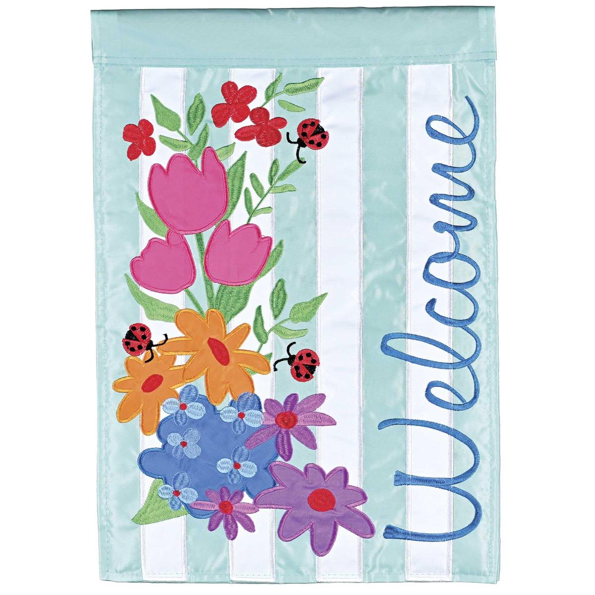 Welcome Floral Garden Flag measuring 13x18 inches with double-sided floral design, displayed on a garden flagpole amidst greenery.