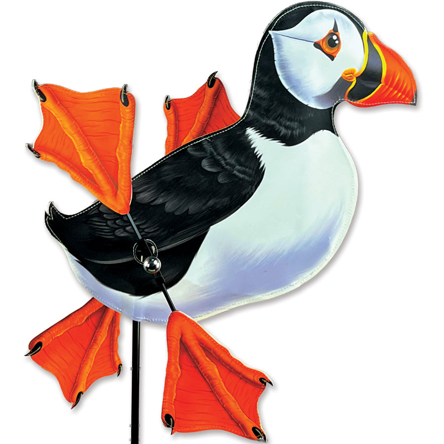 WhirliGig Spinner - Puffin, with orange webbed feet, spinning gracefully in a garden setting, adding whimsical charm to outdoor decor.