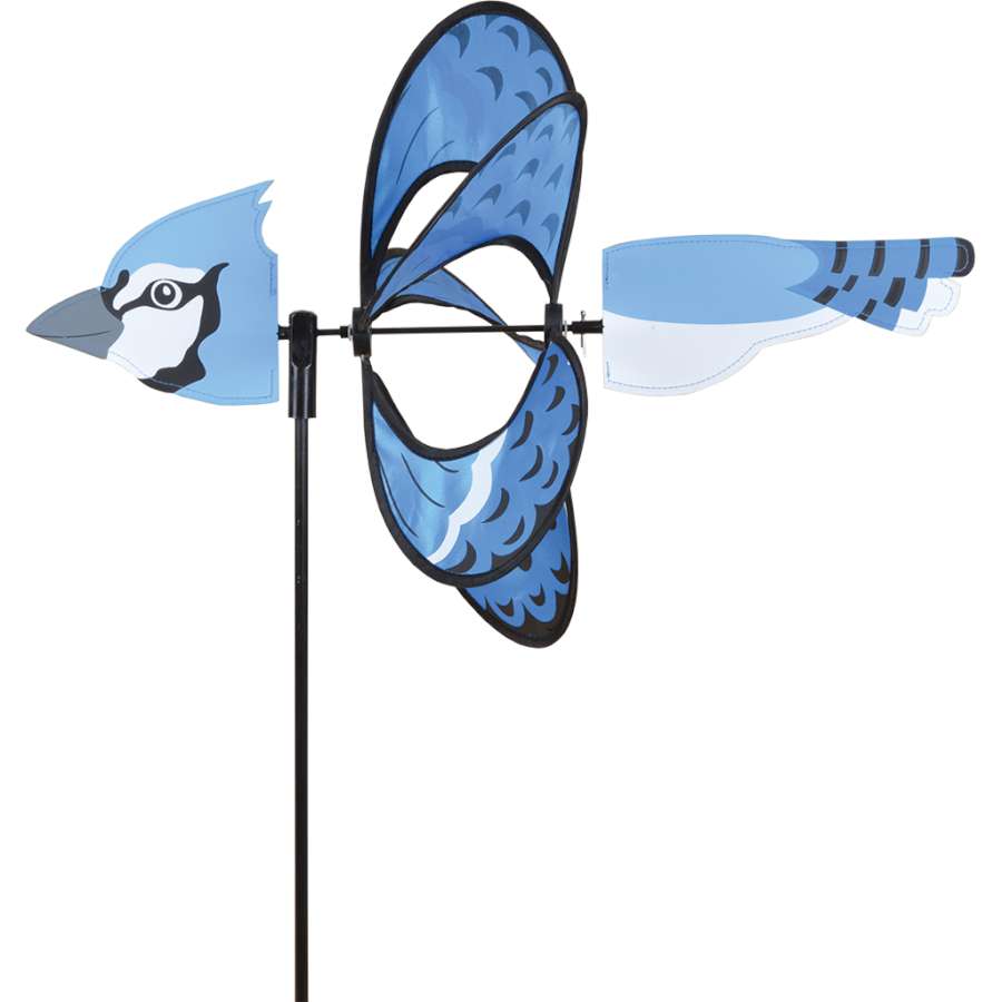 Whirly Wing Spinner - Blue Jay featuring a colorful blue jay design on display in a garden setting, spinning gracefully in the breeze.
