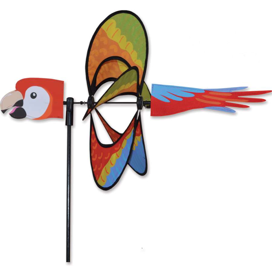 Whirly Wing Spinner - Macaw features vibrant colors and a unique spinning wing design, elegantly displayed in a garden setting.