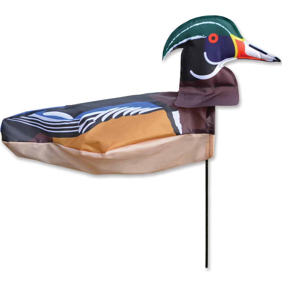 Windicator - Wood Duck vibrant weather vane gently swaying in the breeze, showcasing classic bird design in an outdoor garden setting.