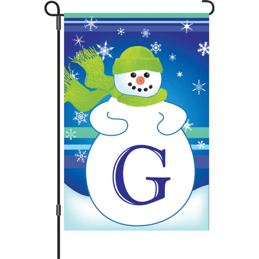 12 in. Winter Monogram Flag - G featuring a vibrant monogram design displayed in a garden setting, ideal for winter decoration.