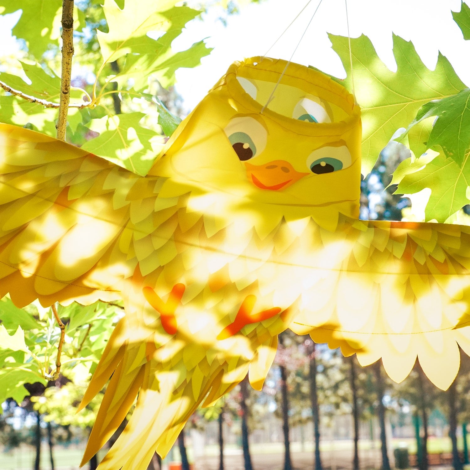 Yellow Bird Windsock in vibrant yellow with outstretched wings, designed for outdoor hanging, swaying beautifully in the breeze.